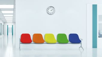Das Bild auf der Startseite der Website Ersteinschätzung zeigt eine leere Stuhlreihe in einer Notaufnahme mit Sitzen in den Farben von rot über orange, gelb und grün bis blau, die das Triage-System veranschaulichen soll.